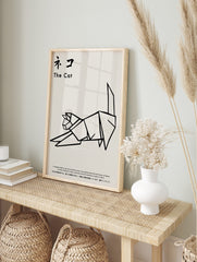 Minimalist black and white origami cat illustration art print with Japanese text, displayed as the same artwork in an alternate framed wall art mockup