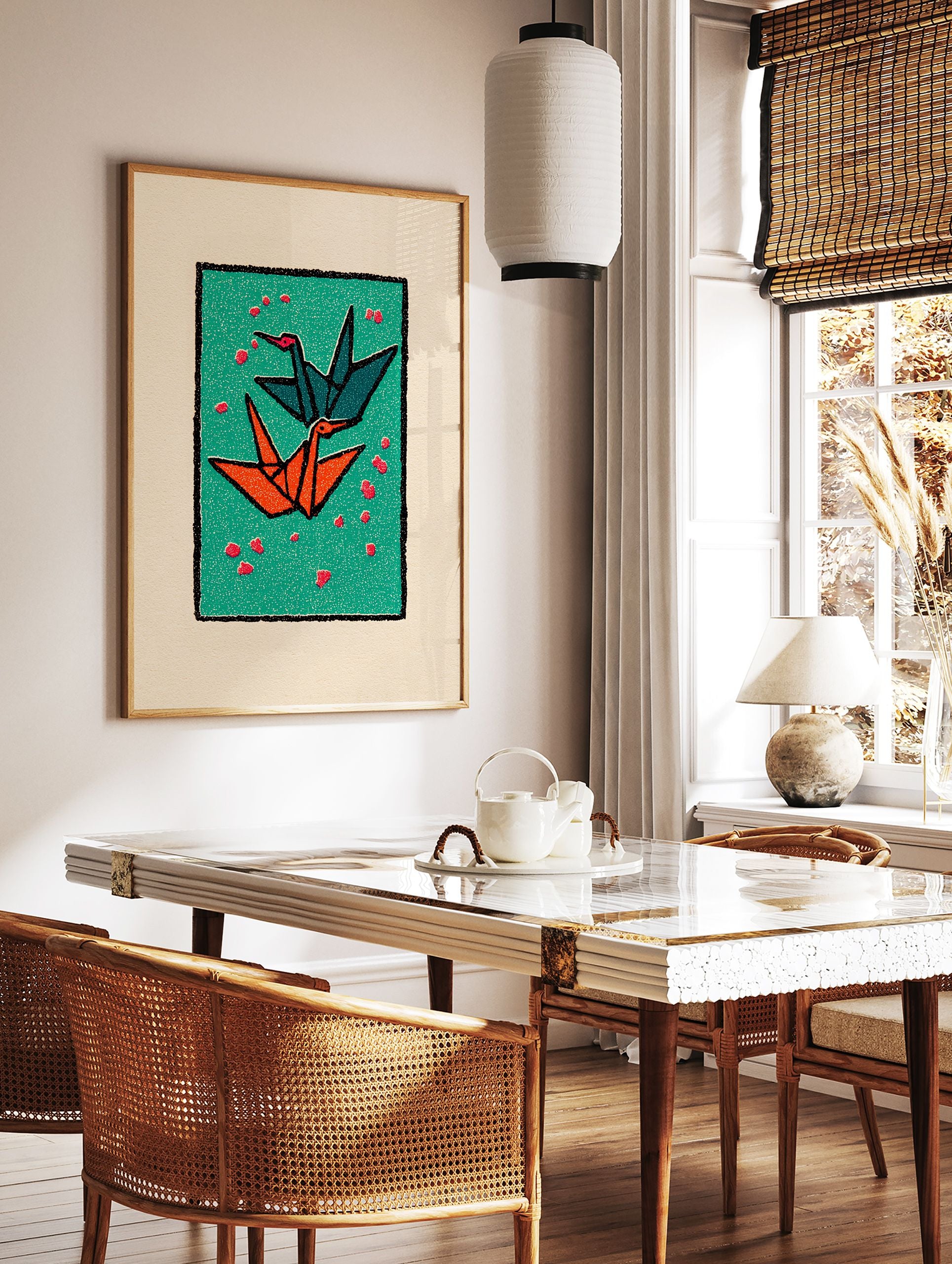Two origami cranes, one teal and one orange, flying on a green background with red petals, framed by black and cream borders. - Image 2