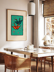 Two origami cranes, one teal and one orange, flying on a green background with red petals, framed by black and cream borders. - Image 2