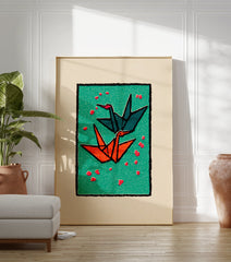 Two origami cranes, one teal and one orange, flying on a green background with red petals, framed by black and cream borders. - Image 3