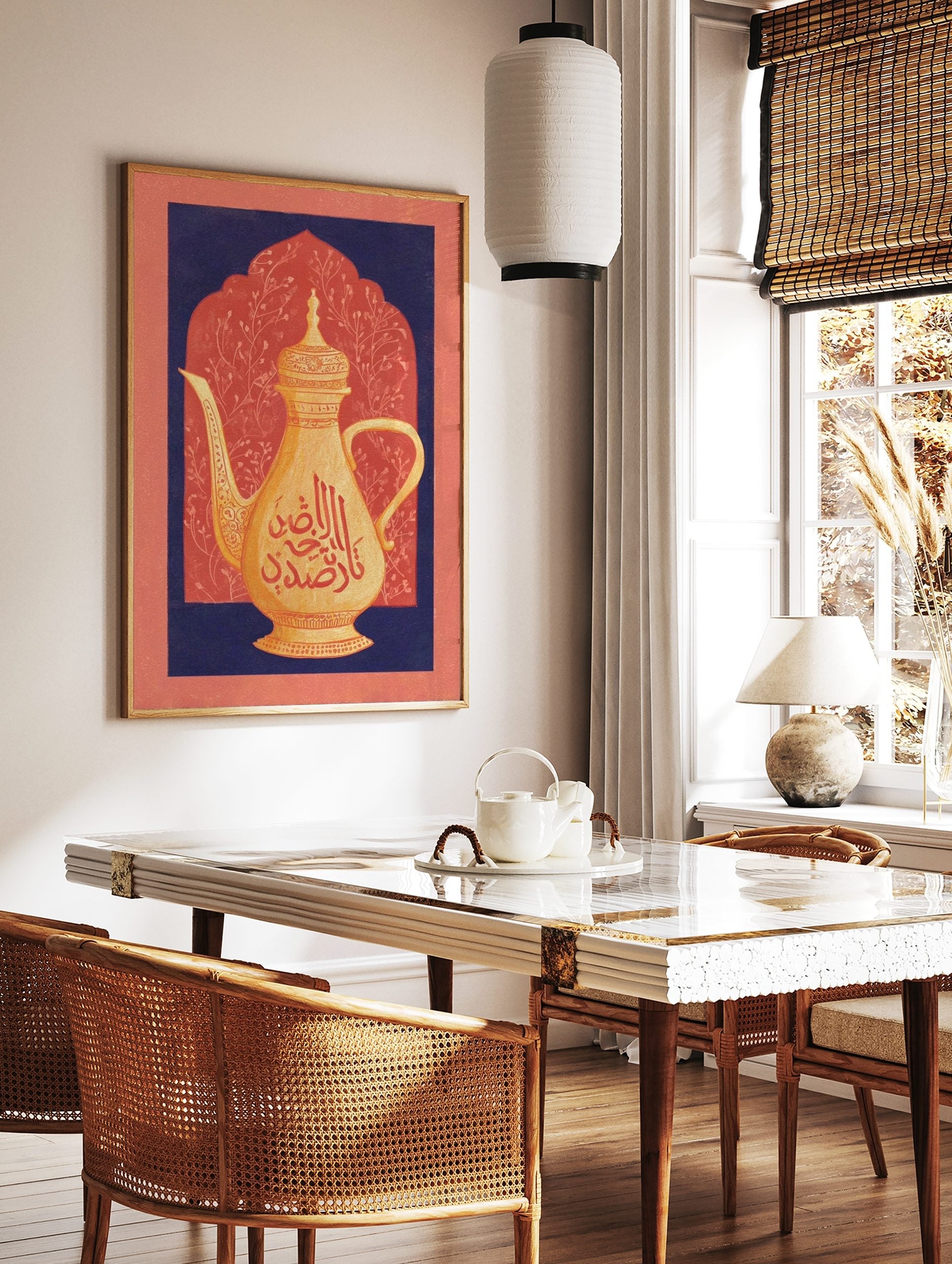 Golden Arabic coffee pot with red calligraphy against a coral arched background framed by navy blue, in a styled room mockup