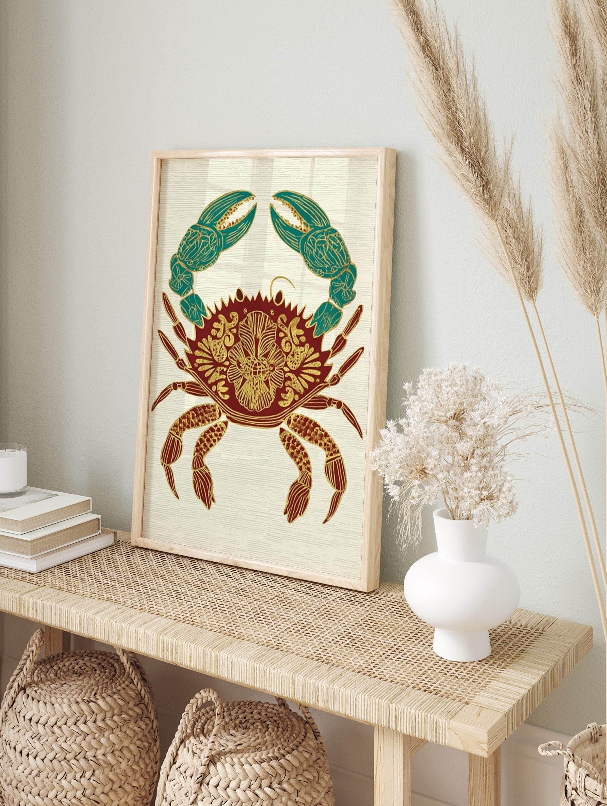 Ornate crab illustration wall art print with gold patterns on a red body and teal claws, on a, in an alternate framed mockup