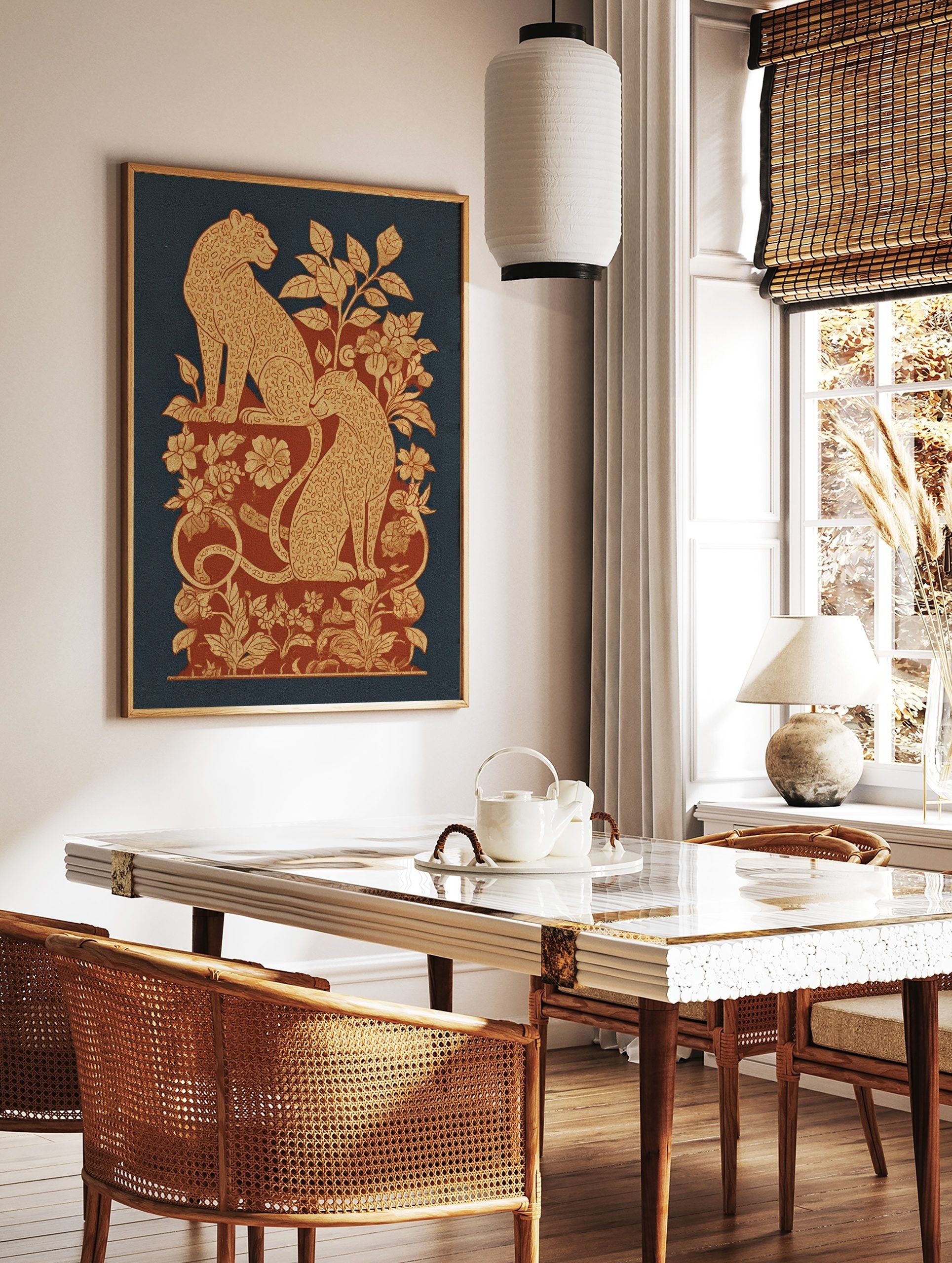 Ornate leopard print with two spotted felines amidst beige and red botanical foliage on a blue, in a styled room mockup