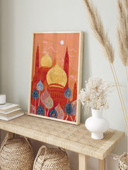 Ornate red and gold mosque domes with tall towers under an orange sky, with blue and red, in an alternate framed mockup