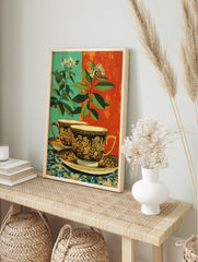 Ornate teacup poster with gold floral design, green leaves, white flowers, and a split teal and orange background. - Image 4