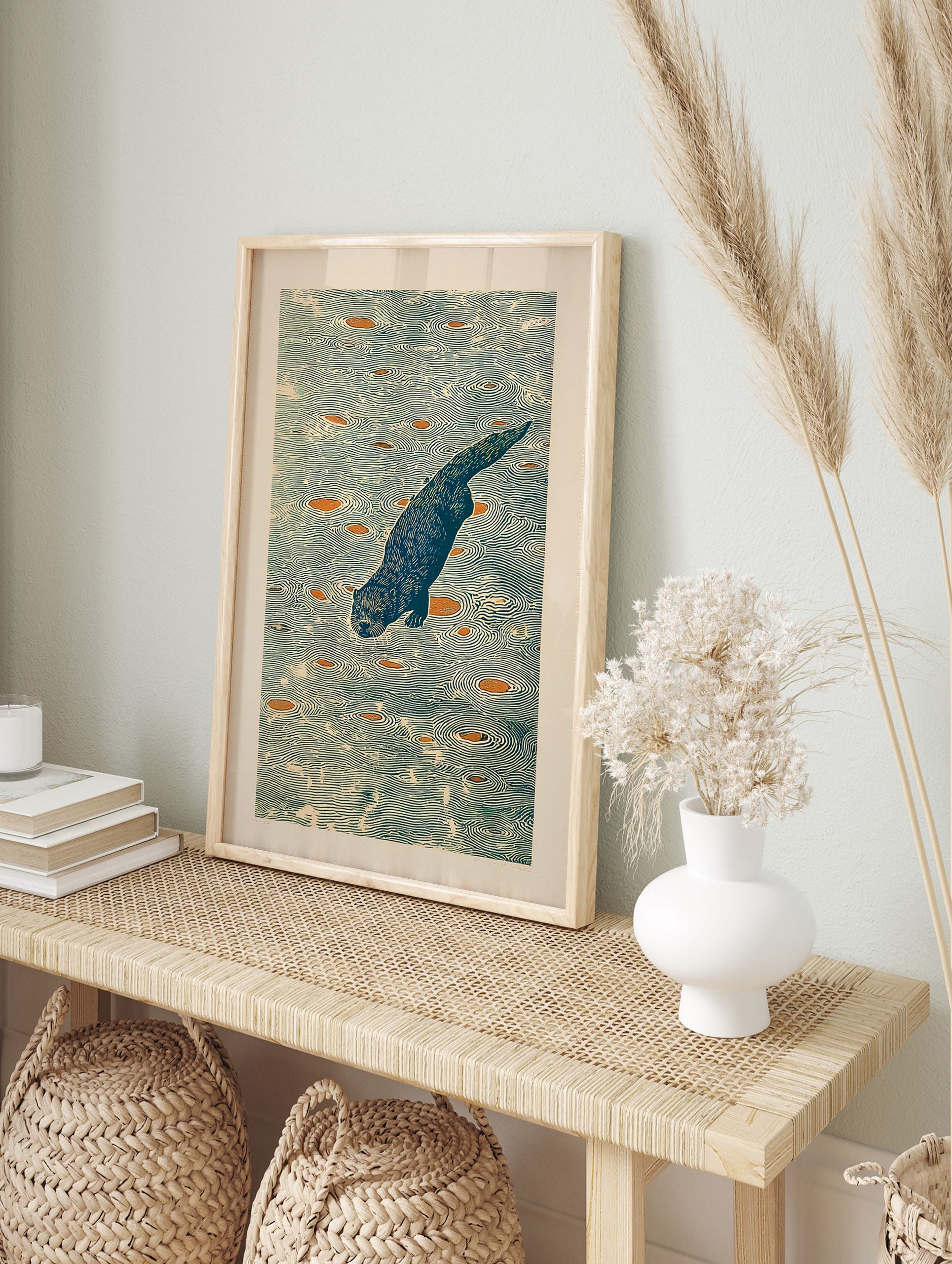 Illustrative woodblock print of a blue otter diving in water with orange shapes and ripple patterns. - Image 3