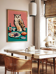 Illustrative art print of a white owl with orange eyes next to a table with grapes, egg, and a, in a styled room mockup