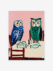 Owl wall art painting featuring two blue and green owls seated at a dining table with a pink background.