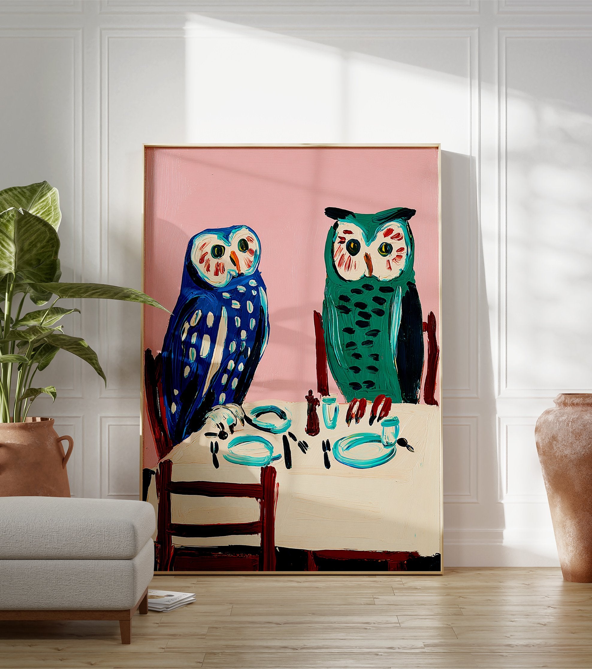 Owl wall art painting featuring two blue and green owls seated at a dining table with a pink background. - Image 3