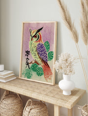 Illustrative owl with red eyes and purple wing on branch, Japanese characters, purple, in an alternate framed mockup