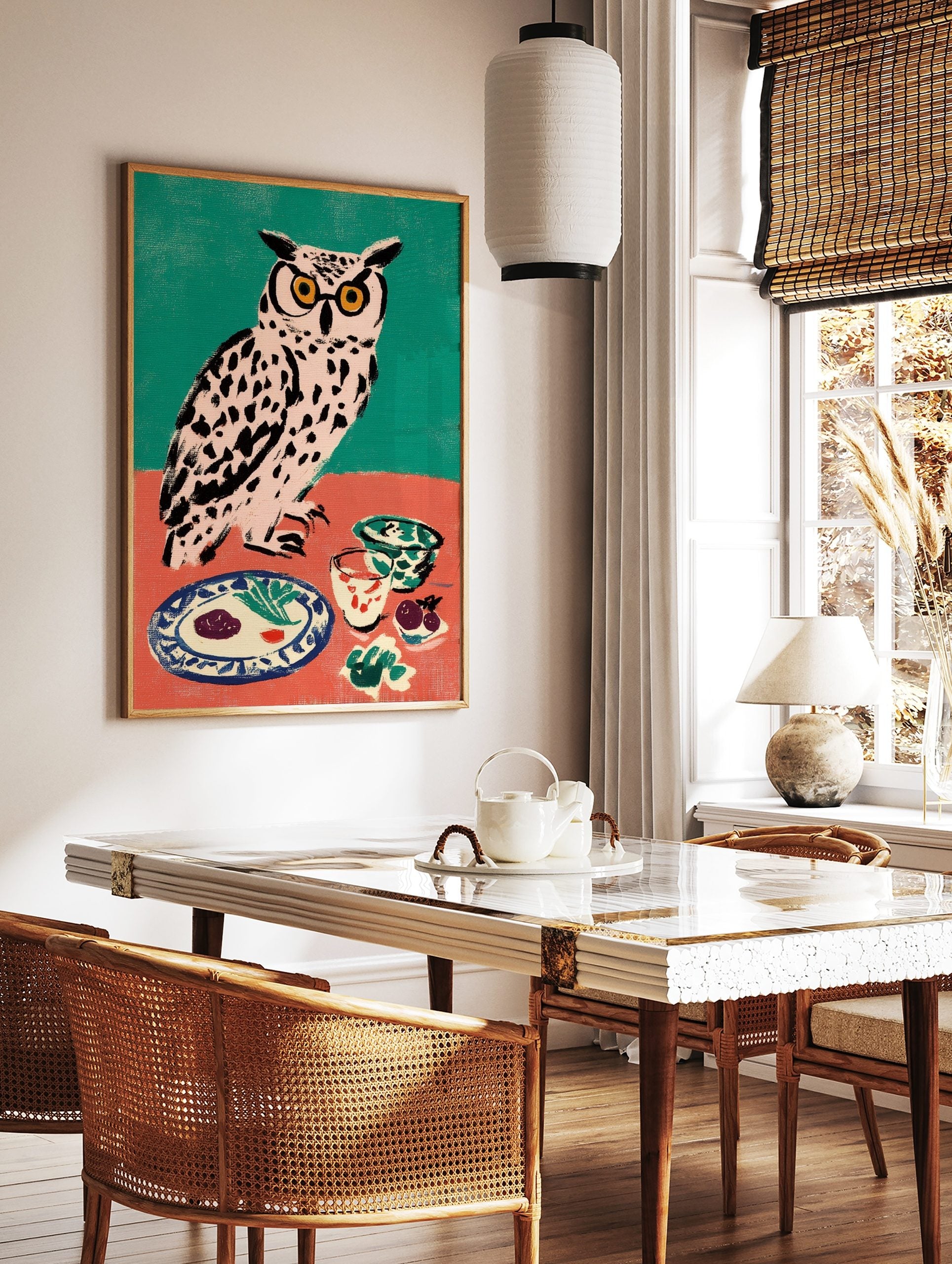 Illustrative owl wall art with yellow glasses at a dinner table, against a teal and coral background, in a styled room mockup