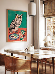 Illustrative owl wall art with yellow glasses at a dinner table, against a teal and coral background, in a styled room mockup