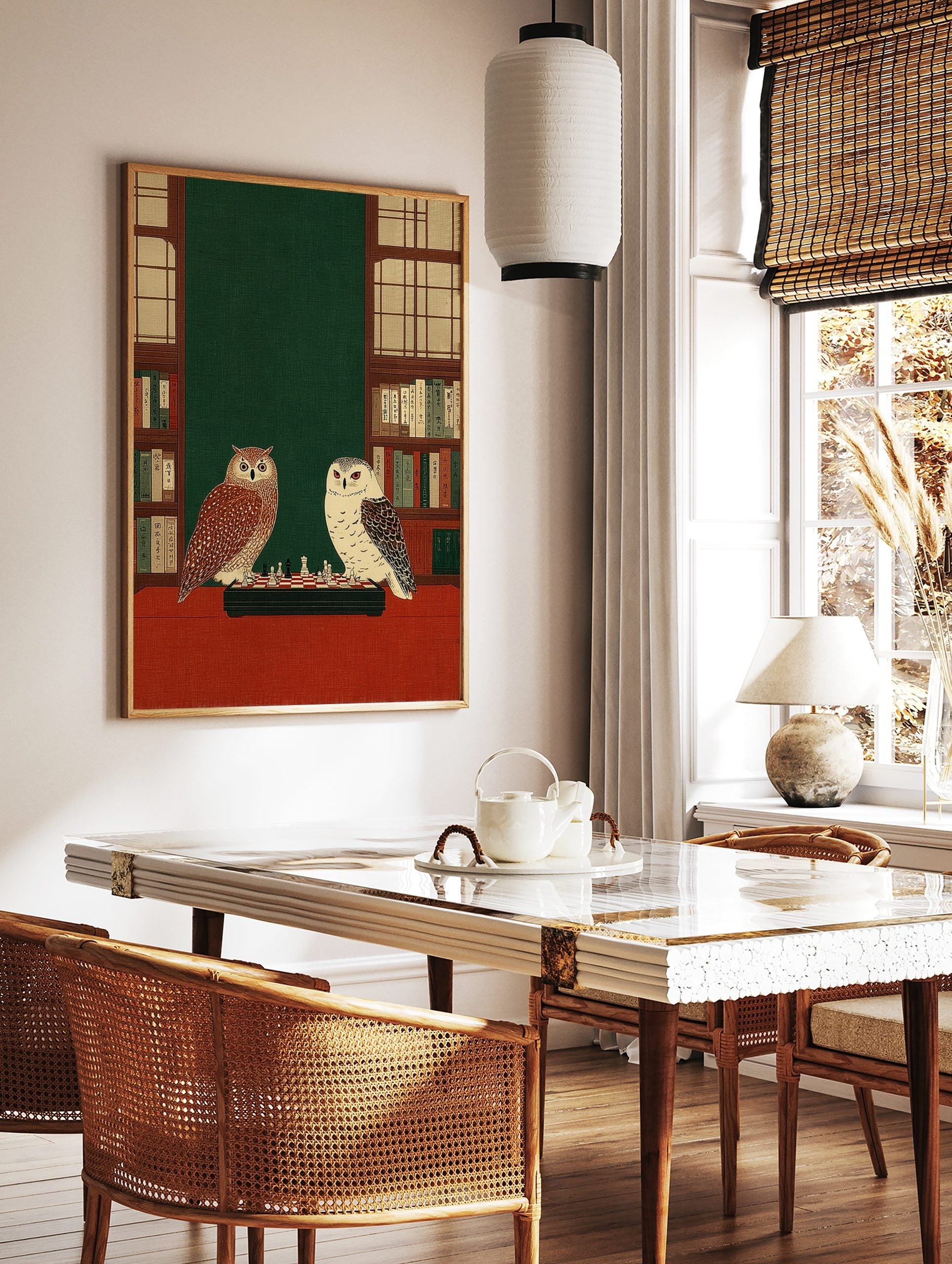 Illustrative print of a tawny owl and a white owl playing chess on a red table, flanked by, in a styled room mockup