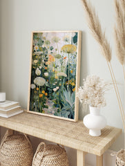 Painterly garden wall art with white, yellow, orange flowers, green leaves, and a cobbled path, in an alternate framed mockup