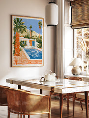 Illustrative art print of a modern desert house with a swimming pool, palm trees, and mountains in, in a styled room mockup