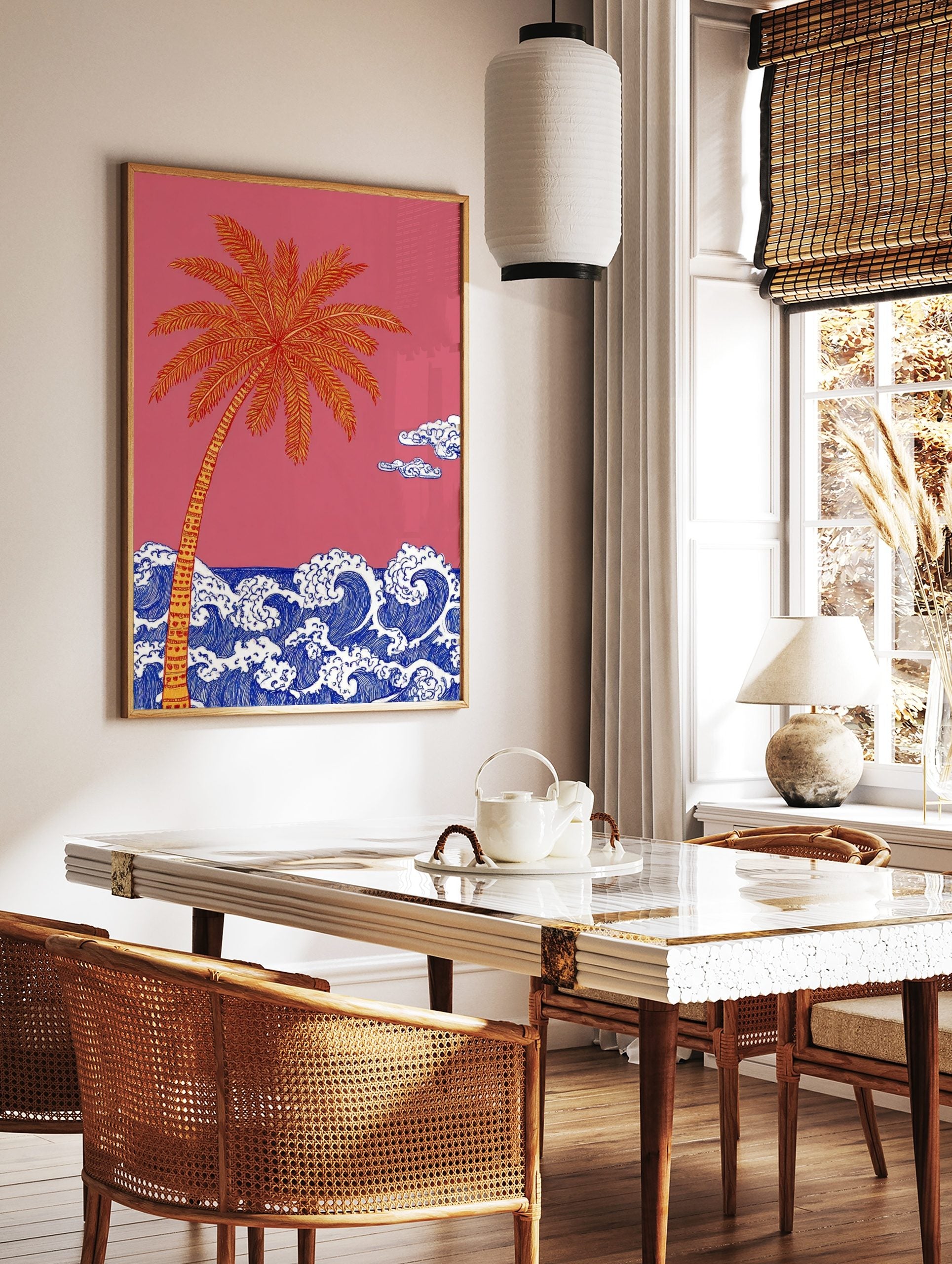 Illustrative palm tree with orange and yellow fronds over blue ocean waves against a pink sky with, in a styled room mockup
