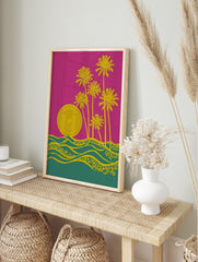 Graphic yellow palm trees, concentric sun, and ornate waves on a pink and teal background, in an alternate framed mockup