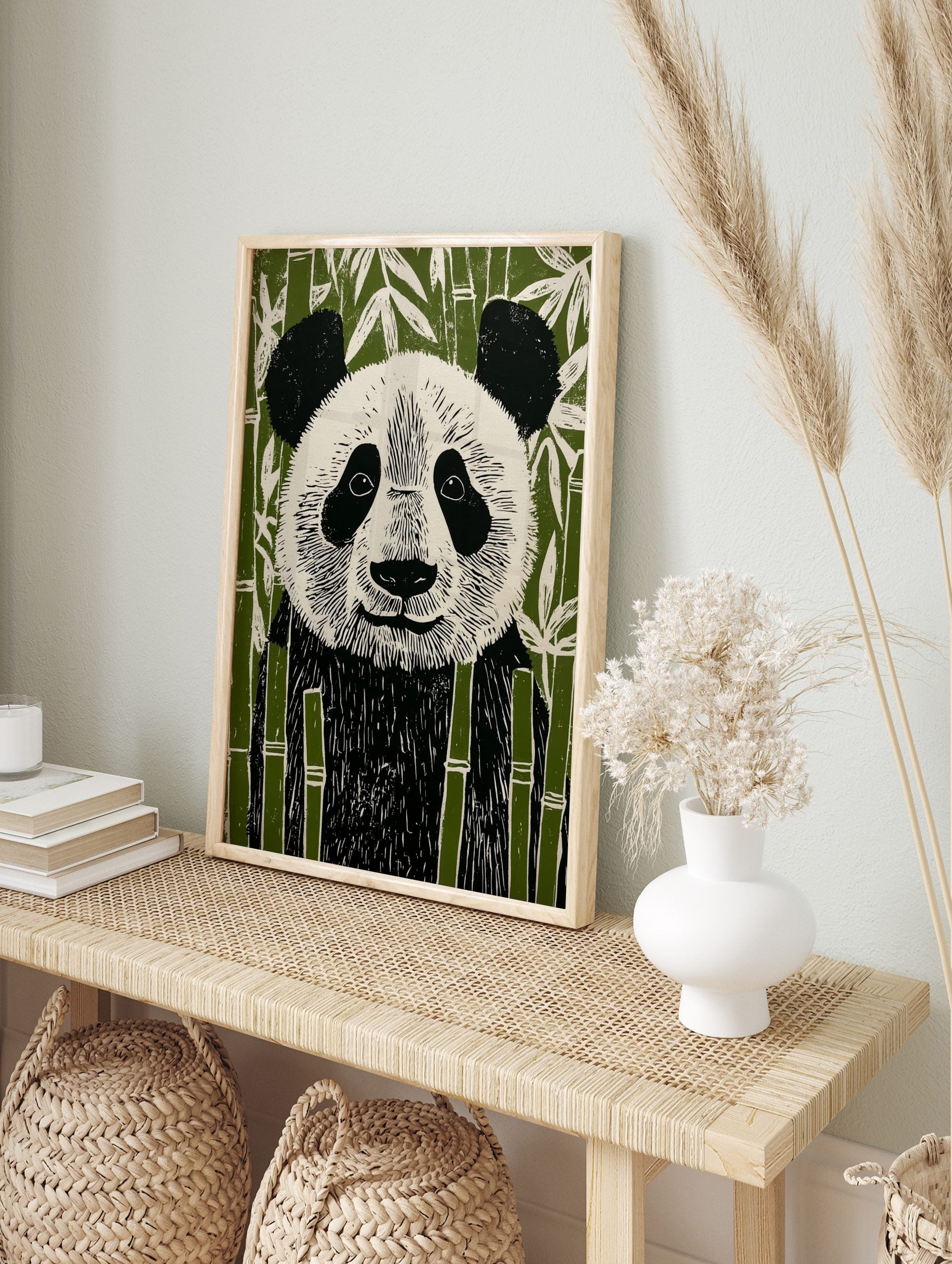 Illustrative linocut style panda bear art print in black, white, and green bamboo forest, in an alternate framed mockup