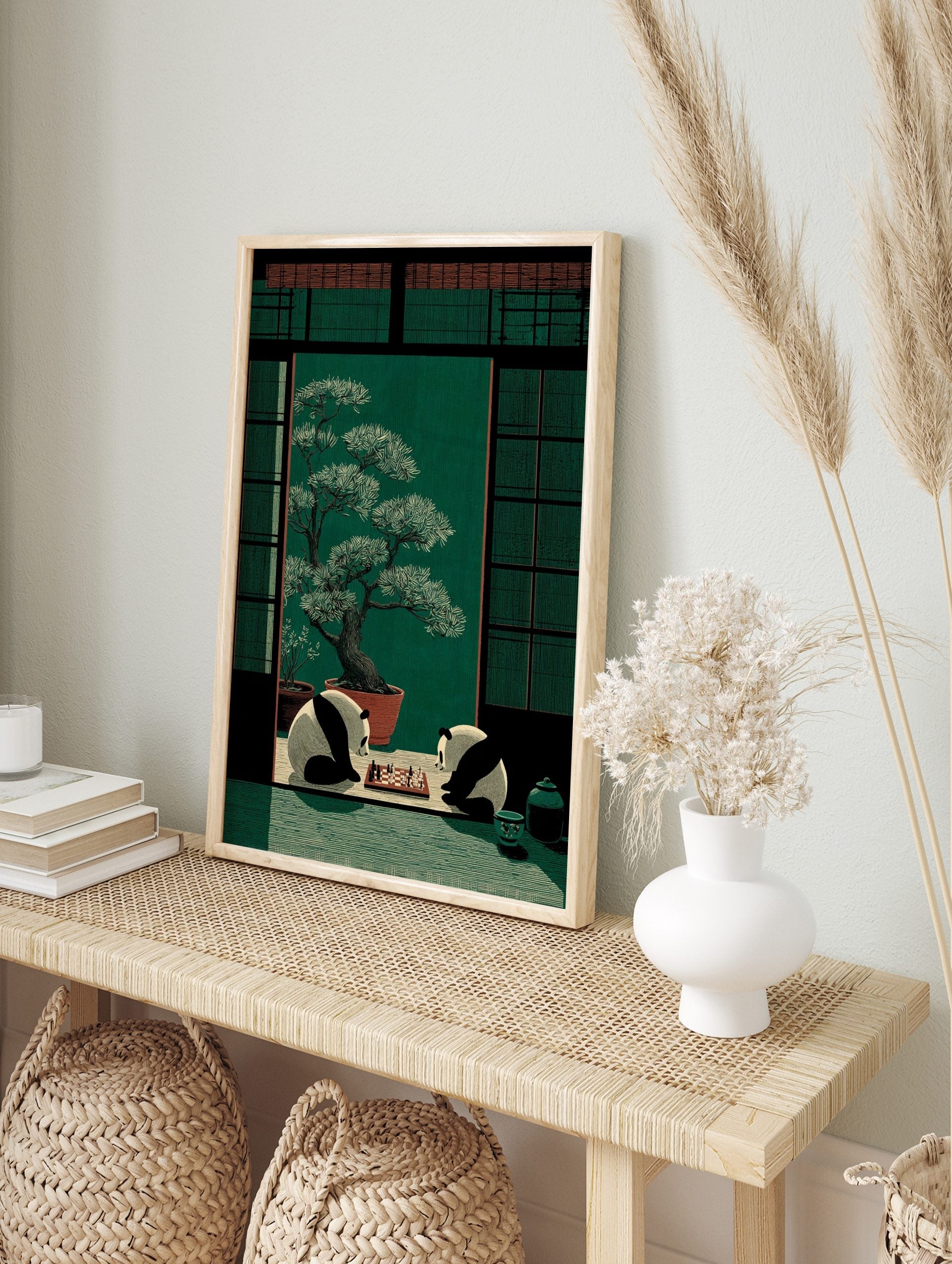 Illustrative print of two pandas playing chess in a Japanese room with a large bonsai tree, in an alternate framed mockup