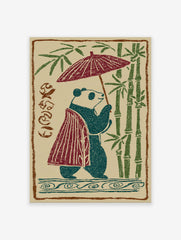 Japanese panda illustration walking with an umbrella and wearing a cape, surrounded by green bamboo stalks on a beige background.