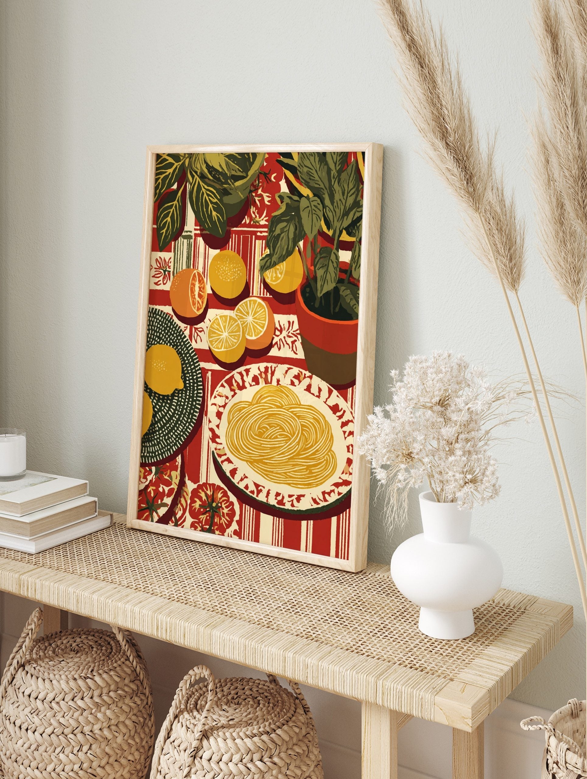 Illustrative still life print of pasta, sliced citrus fruits, and green potted plants on a, in an alternate framed mockup