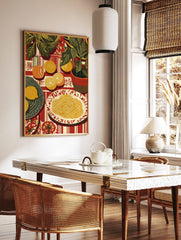 Illustrative still life print of pasta, sliced citrus fruits, and green potted plants on a red, in a styled room mockup