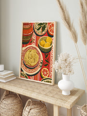 Illustrative still life print of spaghetti, lemons, and grapefruit on a red striped, in an alternate framed mockup