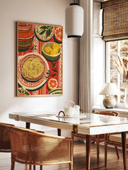 Illustrative still life print of spaghetti, lemons, and grapefruit on a red striped tablecloth with, in a styled room mockup