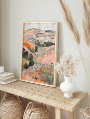 Painterly landscape art print of a pastoral valley with rolling hills, trees, and many, in an alternate framed mockup