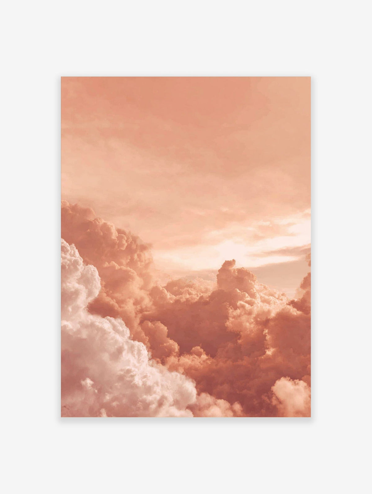 Close-up of voluminous peach and white clouds in a warm sky, appearing dreamy and serene