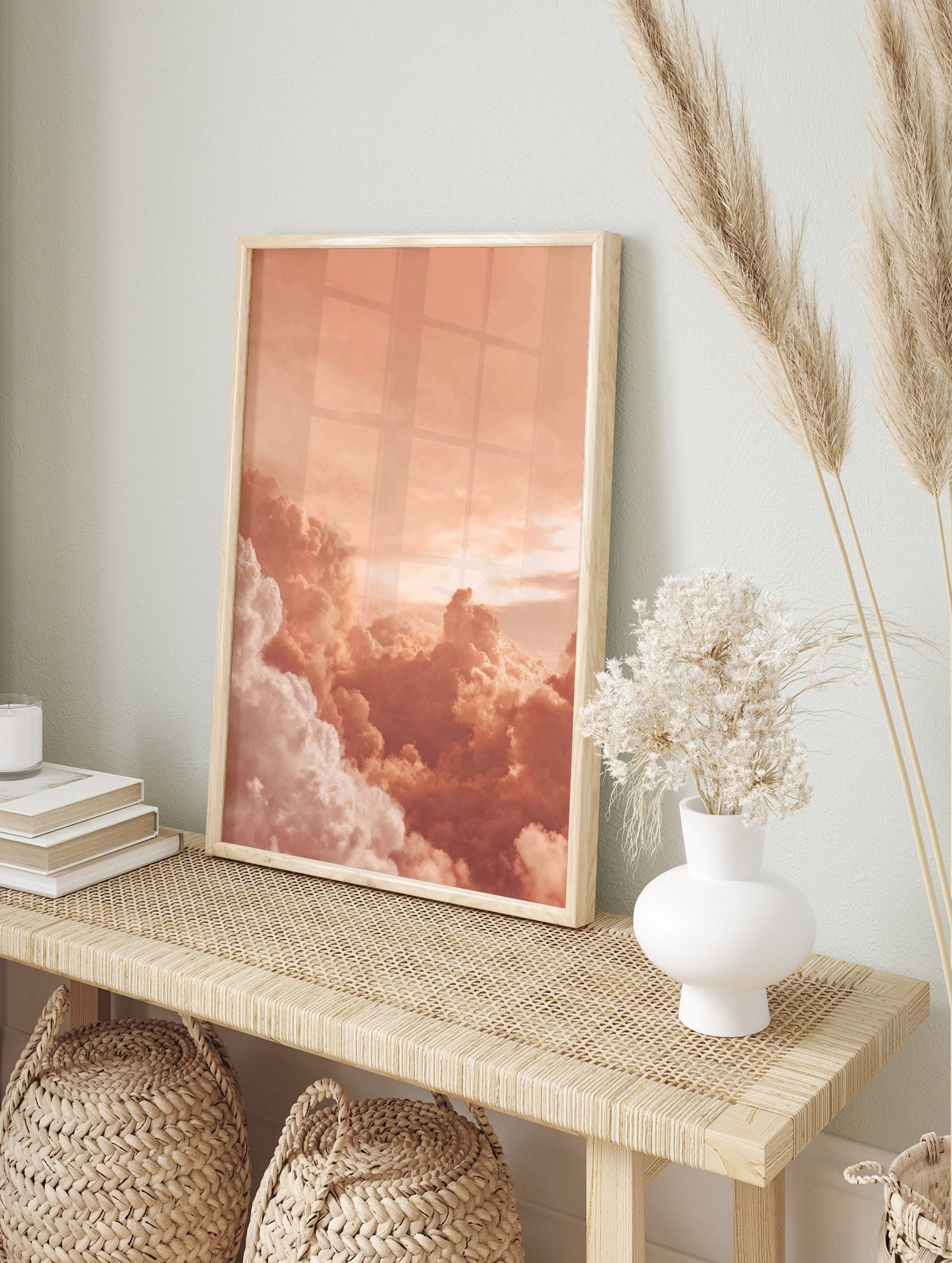 Close-up of voluminous peach and white clouds in a warm sky, appearing dreamy and serene, in an alternate framed mockup