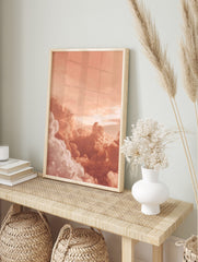 Close-up of voluminous peach and white clouds in a warm sky, appearing dreamy and serene, in an alternate framed mockup