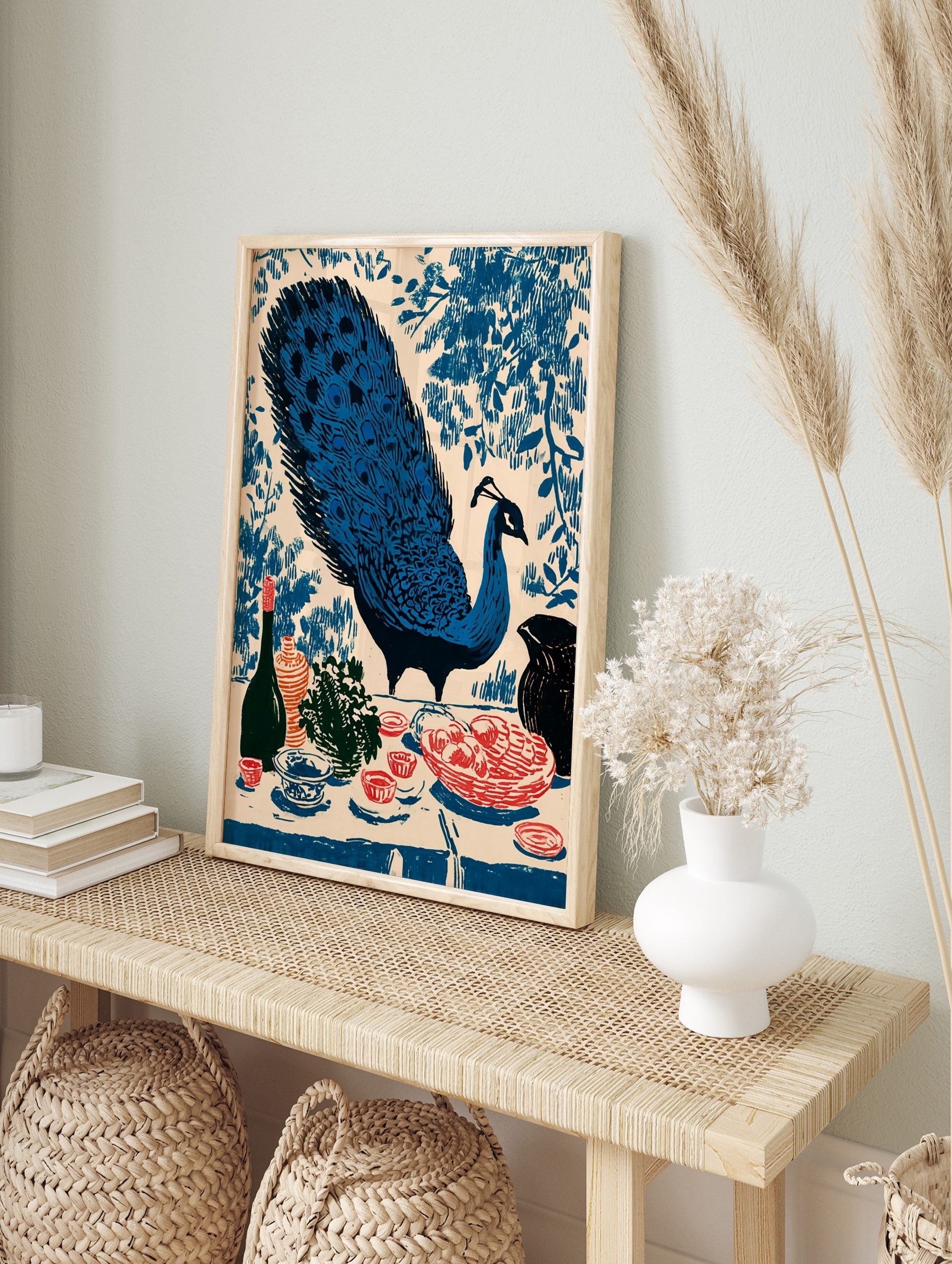 Illustrative blue peacock with fanned tail and still life with fruit, bottle, and vase on a, in an alternate framed mockup
