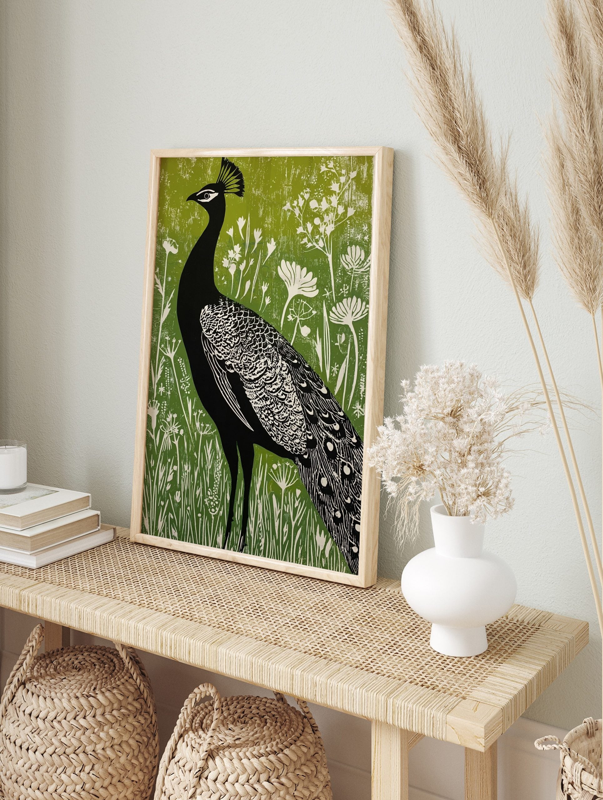 Black peacock silhouette with white details against a vibrant green textured background with, in an alternate framed mockup