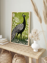 Black peacock linocut illustration with white patterns, green botanical background, and white, in an alternate framed mockup