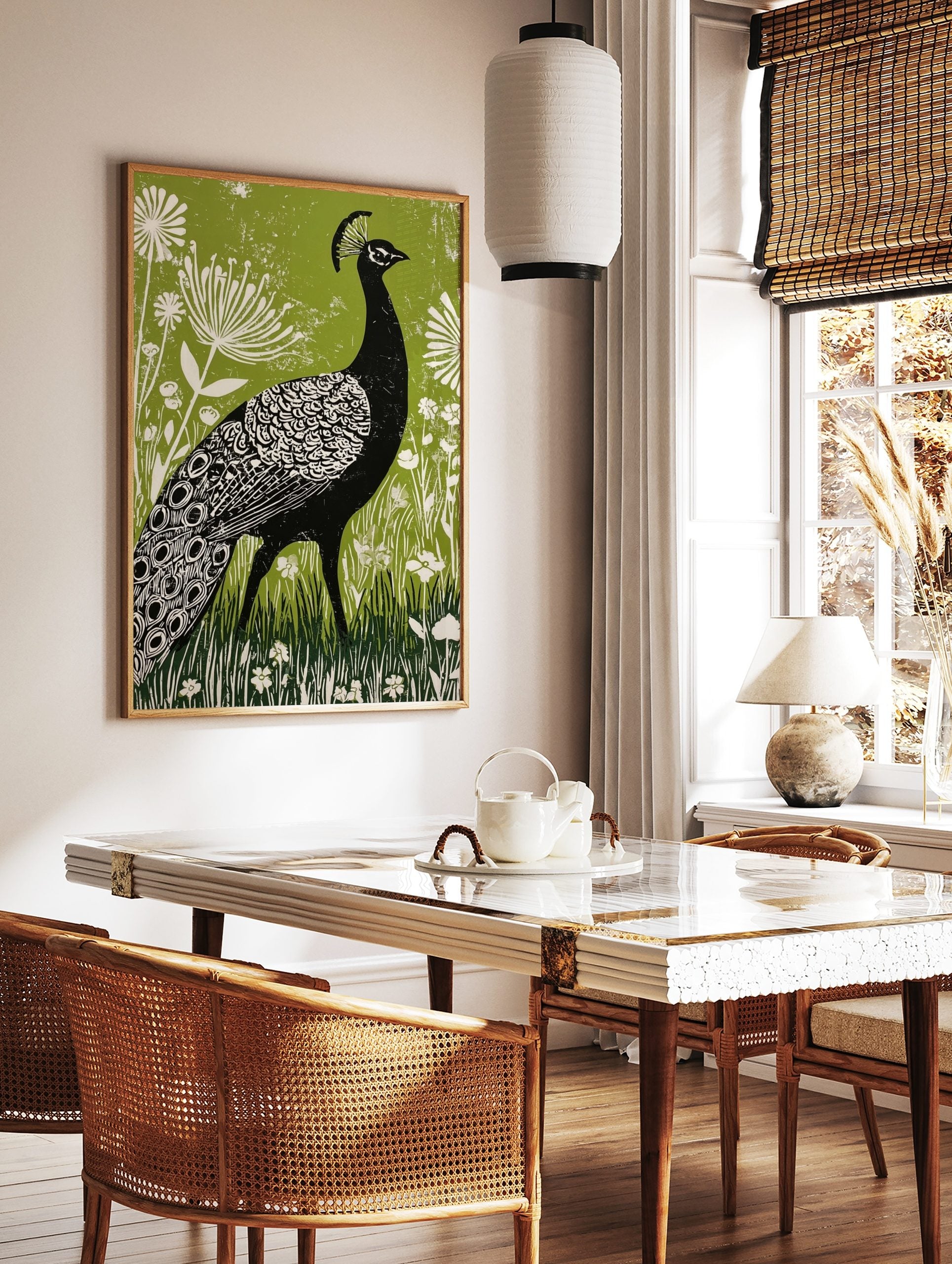 Black peacock linocut illustration with white patterns, green botanical background, and white, in a styled room mockup