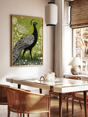 Black peacock linocut illustration with white patterns, green botanical background, and white, in a styled room mockup