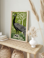 Illustrative black peacock in profile with white feather patterns against a green forest, in an alternate framed mockup