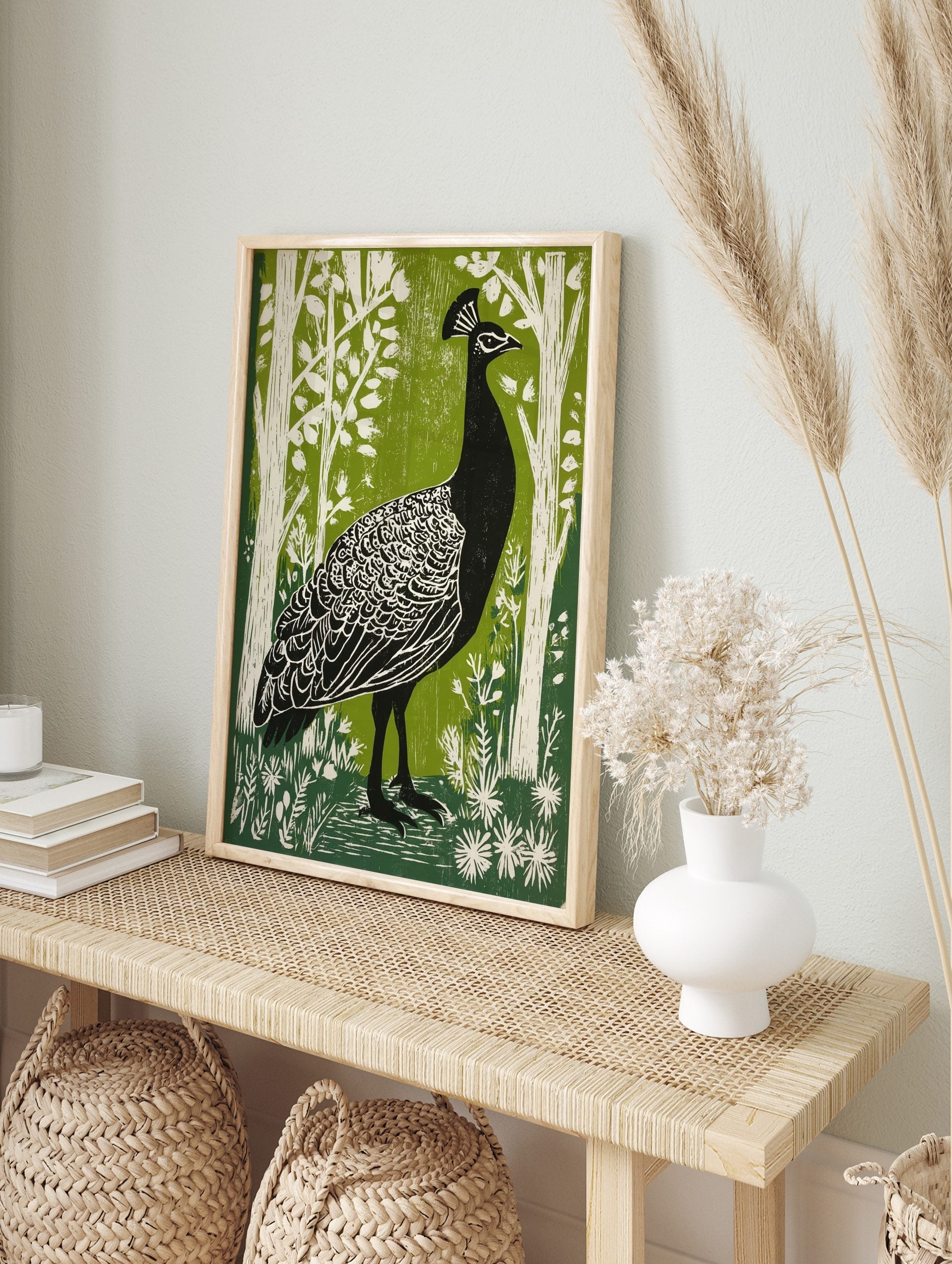 Black peacock with white feather details in green woodland linocut style print, in an alternate framed mockup