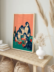 Illustrative print of five penguins having a family dinner with spaghetti, salad, and red, in an alternate framed mockup