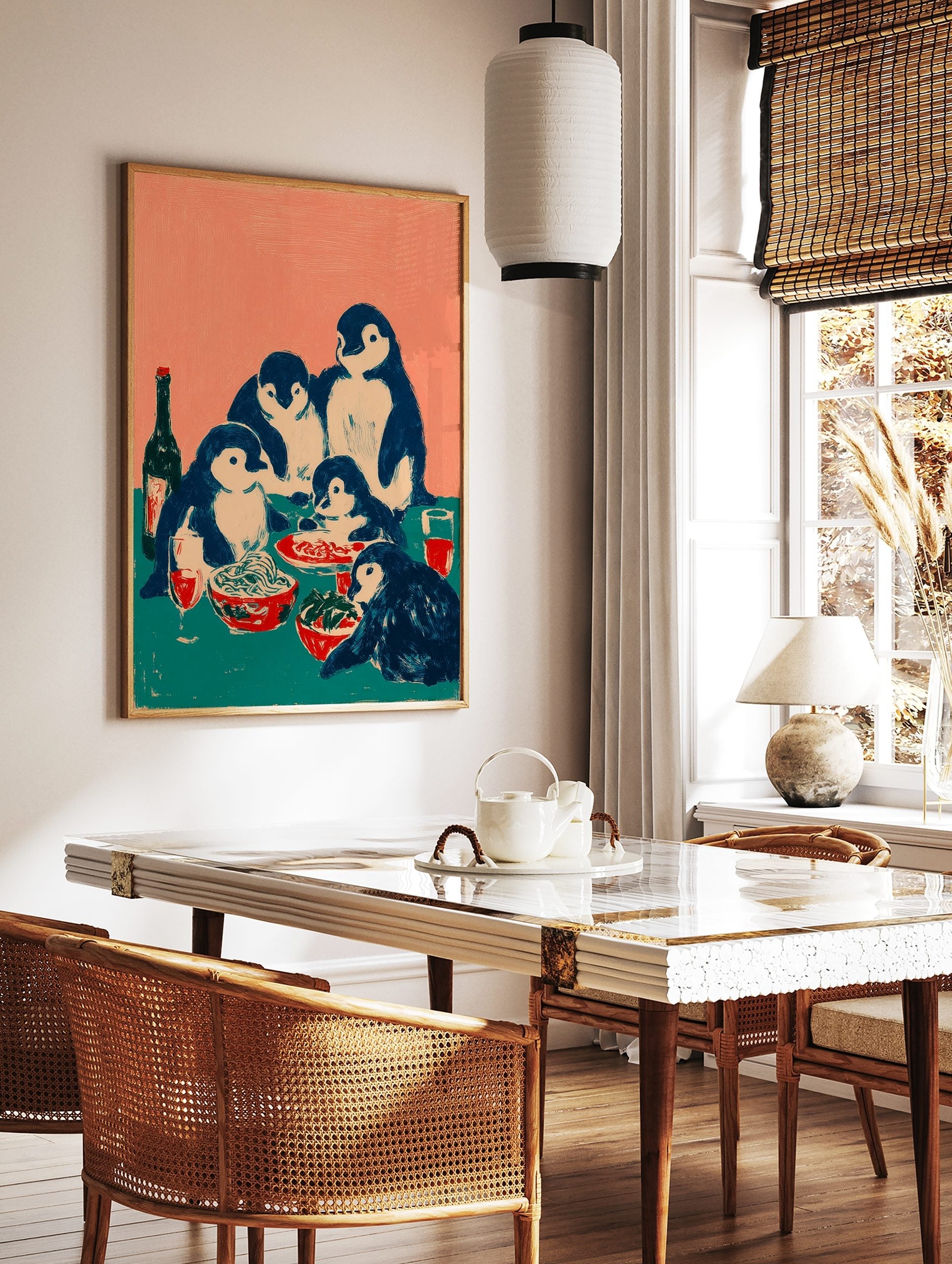 Illustrative print of five penguins having a family dinner with spaghetti, salad, and red drinks on, in a styled room mockup