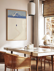 Minimalist illustrative print of a penguin walking in snow, leaving footprints, with blue mountains, in a styled room mockup