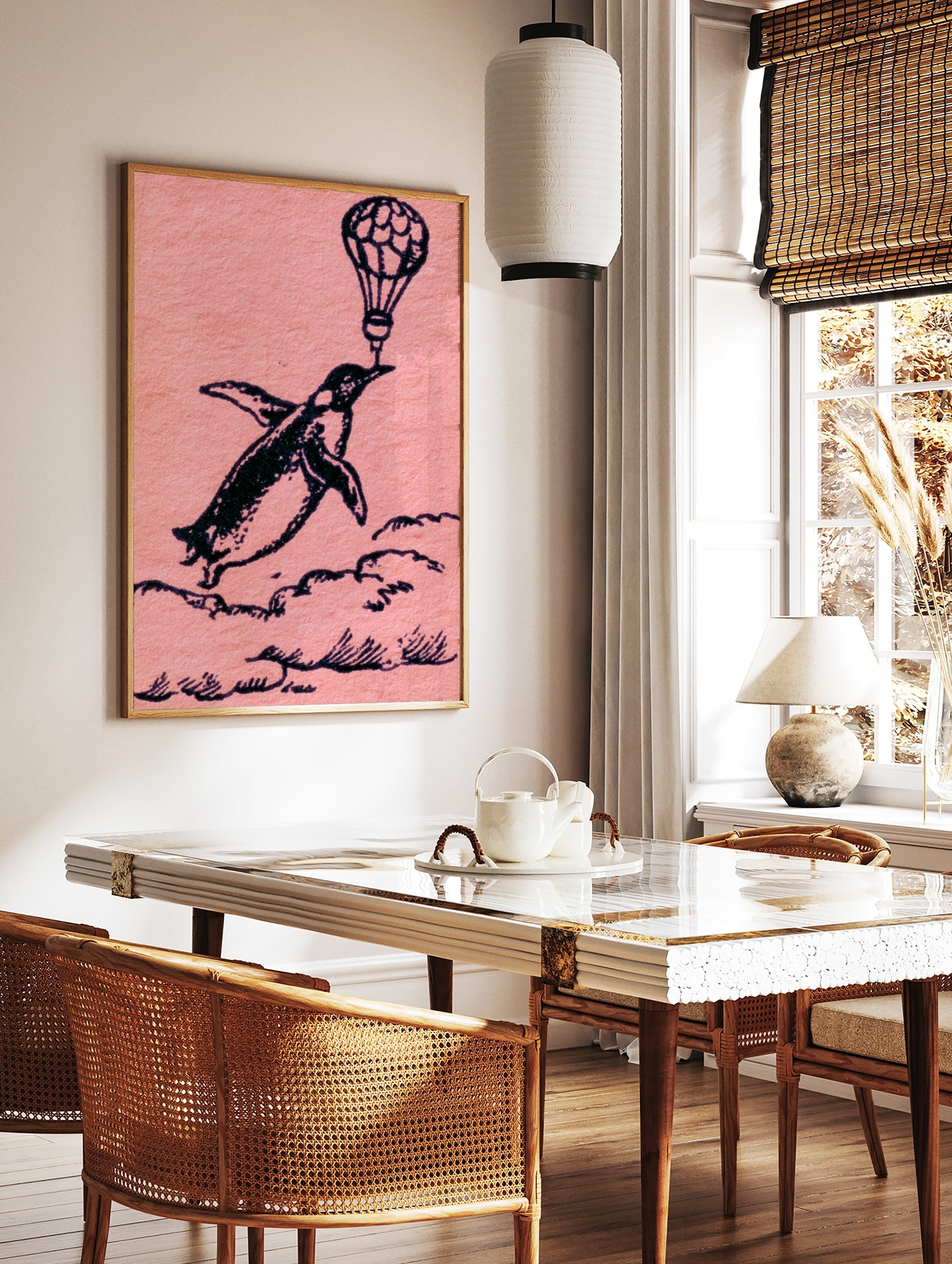 Whimsical black ink illustration of a penguin flying while holding a hot air balloon on a pink, in a styled room mockup