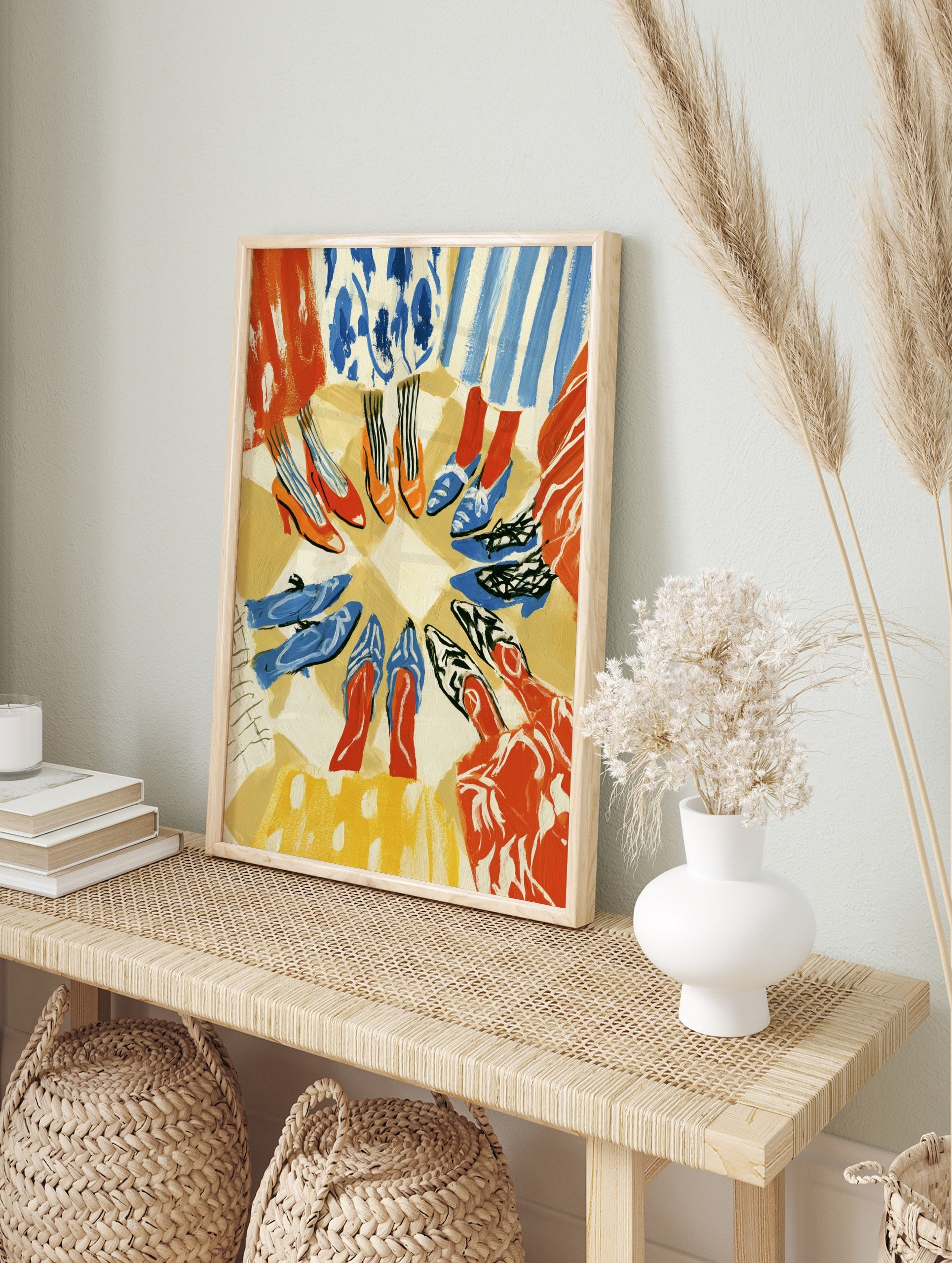 Fashion illustration print of a circle of diverse shoes and colourful clothing on a neutral, in an alternate framed mockup