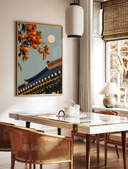 Illustrative orange persimmon fruit on a branch above a traditional tiled roof with a full moon in, in a styled room mockup