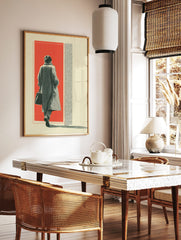 Figure in long coat walking into red background with halftone texture and cream border, in a styled room mockup