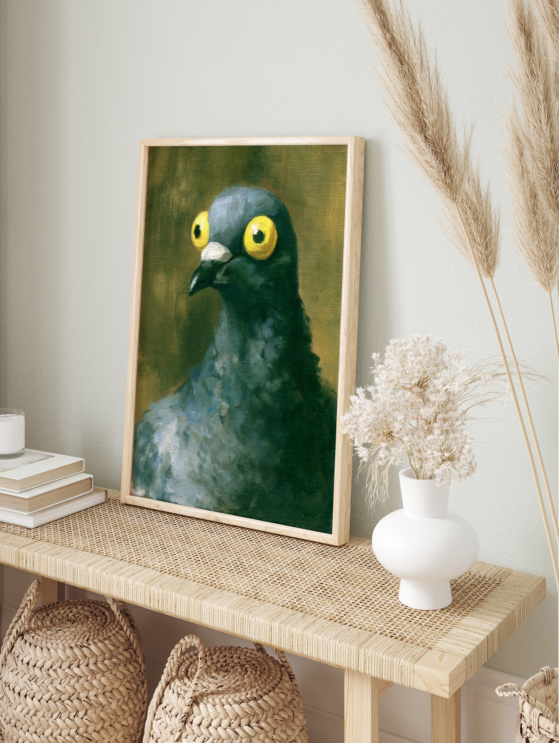Close-up painting of a pigeon with large yellow eyes and textured dark feathers against a, in an alternate framed mockup