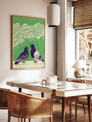 Illustrated pigeon wall art showing two dark birds in foreground, with green and cream cityscape and water in background. - Image 2