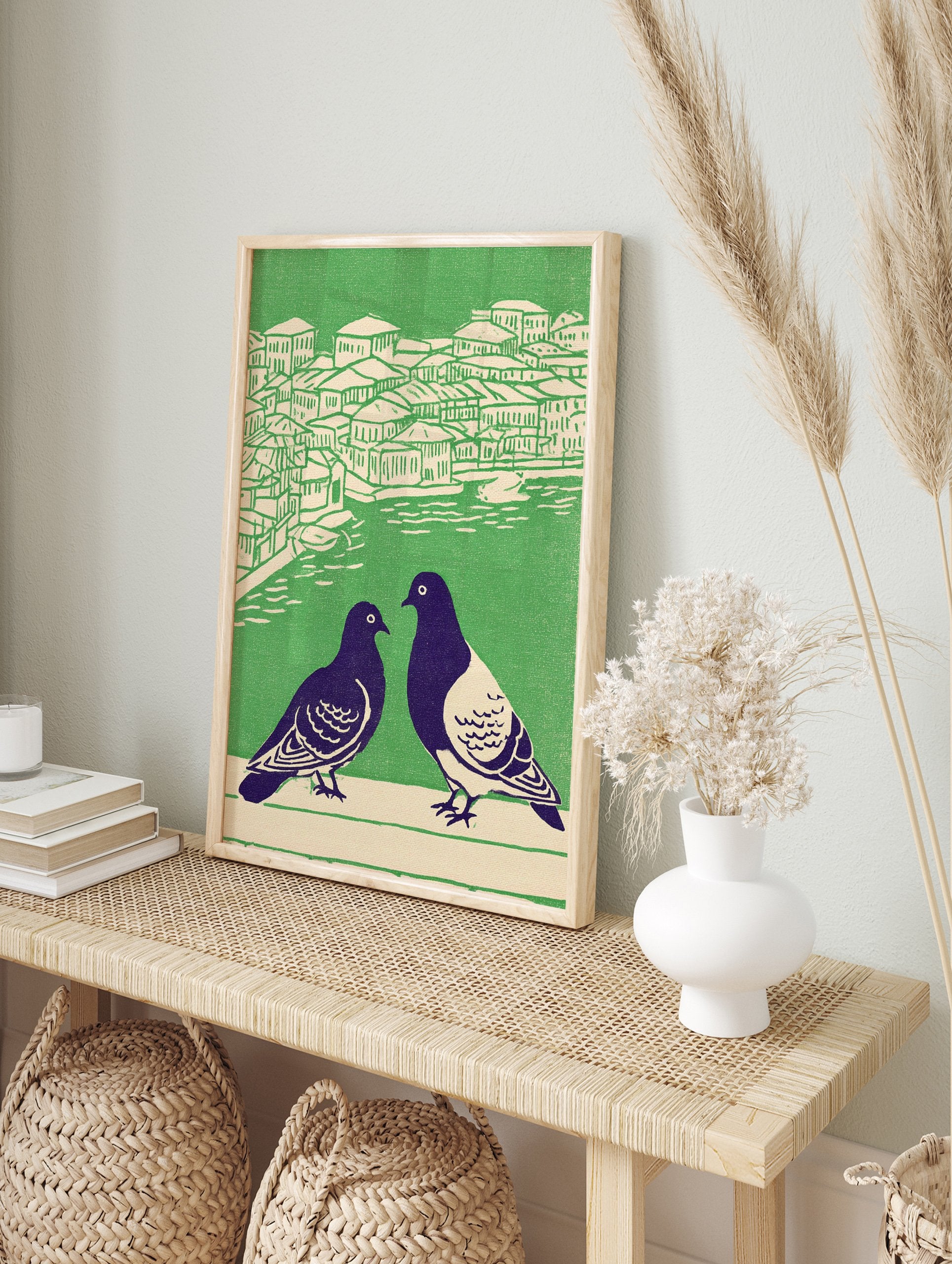Illustrated pigeon wall art showing two dark birds in foreground, with green and cream cityscape and water in background. - Image 3