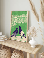 Illustrated pigeon wall art showing two dark birds in foreground, with green and cream cityscape and water in background. - Image 3